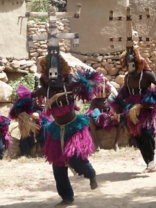 Dogon tribal dancers, wearing traditional costumes, perform for...
