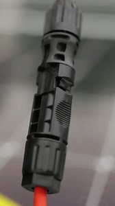 Vertical Screen: Close up of connecting electric cable to solar panels at solar power plant. Connection and installation of solar panels. Solar panel on the background.