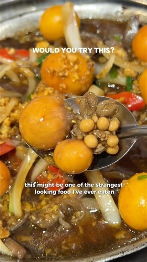 Trying exotic food in Hanoi's Old Quarter. Unlaid chicken eggs