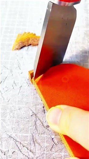 Blade slices leather clean, crisp rhythm of morning cutting craft