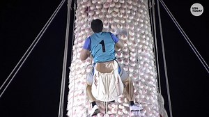 This unique event includes people climbing a tower of buns... at midnight! | USA TODAY Video