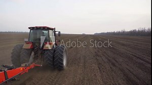 Agriculture. Aerial video shooting. Trailed mechanical seeder. Kuhn. Spring sowing. Sowing the field. Tractor MTZ