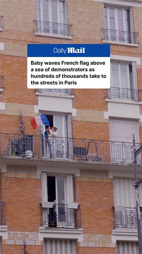 A baby and mother waves the French flag above a sea of demonstrators as hundreds of thousands take to the streets across France for another weekend of protests. #ParisProtests #France #DailyMail #Protests #Police