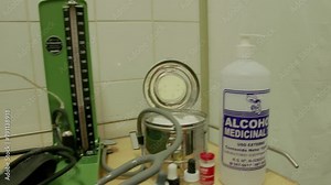 plastic aluminum objects needles wires cables cases scissors knives deposits wallets on a trolley-type aluminum material table prepared for a medical examination and a donation