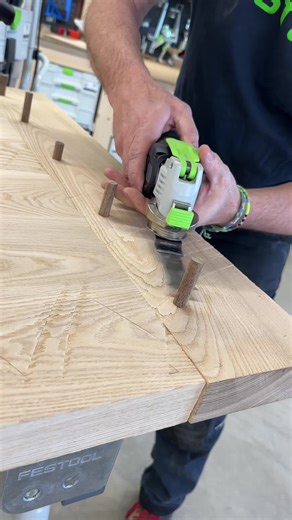 Trimming down the walnut draw bore pegs with the @Festool Canada OSC 18 cordless oscillator and then using the OF 1010 router to get it almost flush and then the ETS EC 150 sander to get it sanded perfectly