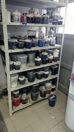 Diverse Paint Container Showcase in Indoor Storage
