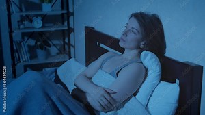 Insomnia in a lonely woman lying in bed in the bedroom.