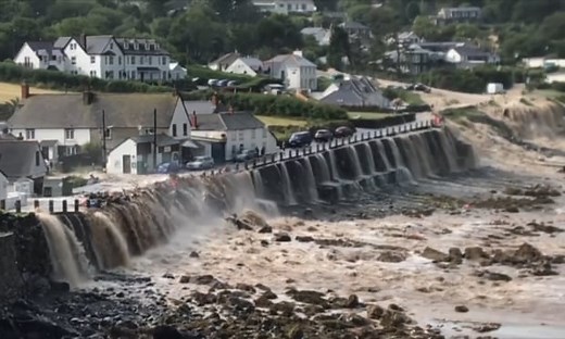 Cornwall flooding: footage shows elderly couple's dramatic rescue – video