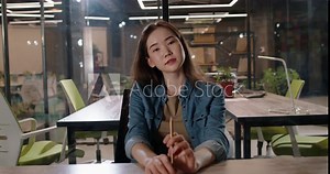 Young female asian student listening to a lecture by tutor online. Attentive elearner doing distance university or school education 4k footage