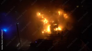 House fire. Firefighter battling flaming fire. The fireman extinguishes an open fire. 4K. Stock Video