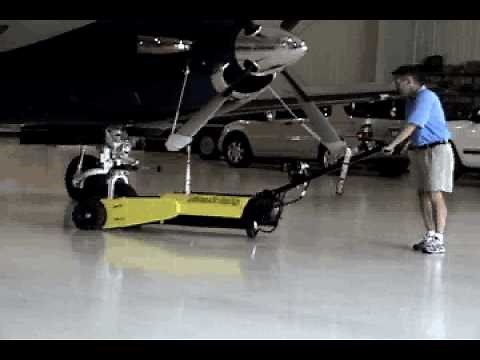 An aircraft tow pulls large aircraft in an airplane hangar
