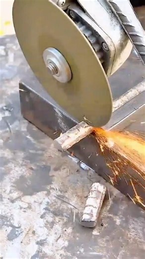 cutting the iron reinforcement bar using a large automated circular electric steel saw machine