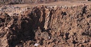 Soil layer with backhoe, backhoe working digging, construction site