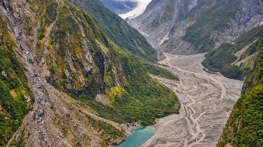 Fox Glacier in New Zealand flowing through a green valley