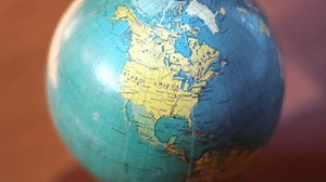 Close-up of spinning globe showing Atlantic Ocean and surrounding continents