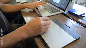 Digital business and design concept.Focus human 's hand is working with drawing by pen tablet for a laptop computer, Selective soft focus shot (Full HD,1080p 60fps).