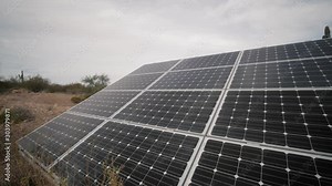 Pan over residential solar panels on a cloudy day. The overcast sky can limit the effectiveness of the photovoltaic cells. Clean solar energy is essential to the Green New Deal.