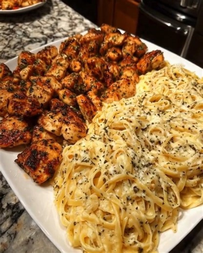 Garlic Butter Chicken Linguine in Creamy Parmesan Mozzarella Alfredo Ingredients: 1 pound boneless, skinless chicken breasts, cut into bite-sized pieces 2 tablespoons olive oil Salt and black pepper, to taste 1 teaspoon Italian seasoning 12 ounces linguine pasta 4 tablespoons unsalted butter 4 cloves garlic, minced 2 tablespoons all-purpose flour 2 cups heavy cream (or whole milk for lighter version) 1 cup grated Parmesan cheese 1 cup shredded mozzarella cheese 1/4 teaspoon garlic powder (option