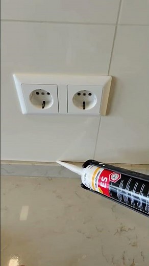 Finishing the kitchen splashback. Caulking with jasmine silicone to match the grout and tiles.