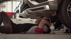 Download The mechanic is practicing the car's suspension. for free