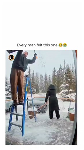 Busted Tees on Instagram: "Bells rang hard that day Follow @bustedtees for more! This funny couple fail video shows a husband cleaning snow off the roof using a snow shovel during winter, thinking everything was going smoothly until a hilarious accident happened. After handing the shovel to his wife, she casually placed it on the ground without realizing it was set up for disaster. As the husband climbed down the ladder from the roof, he stepped right between the shovel just as his wife accident