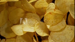 Super Slow Motion Shot of Potato Chips Flies After Being Exploded against Black Background, 1000fps. Shooted with High Speed Cinema Camera at 4K.