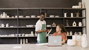 Clerk Holding A Clipboard And Talking With His Female Colleague In The Pottery Shop | Free Stock Video Footage