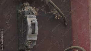 turn on old black automatic fuse, man's hand close-up turns on light in old switchboard