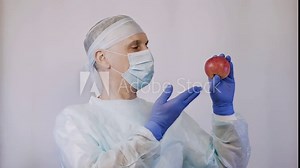 The doctor points to an apple. And the gesture makes it clear that these are the best natural vitamins for health.