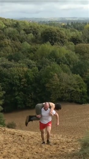 Strong man carries woman up HUGE Sand Dune