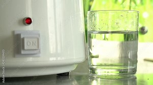 Production of clean water or alcohol. Table home or chemical laboratory Distiller for production of pure water. Process of cleaning fluid. Alcohol mashine. Water dropping into glass. Close up