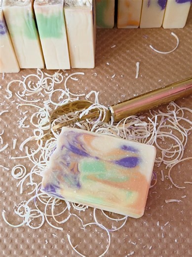 Bright and enticing, Fiesta bar soap begins with vibrant scents of lime, juicy pineapple, sun-ripened orange, ripe raspberry, and vanilla. The fragrance is sweet, lively, and utterly delightful, evoking nostalgic memories of candy and ice cream shops. Handcrafted with shea butter and coconut milk, this bar soap produces a rich, creamy lather that gently cleans the skin. After using it, you may feel smooth, refreshed, and beautifully renewed. #reminissoaps #barsoap