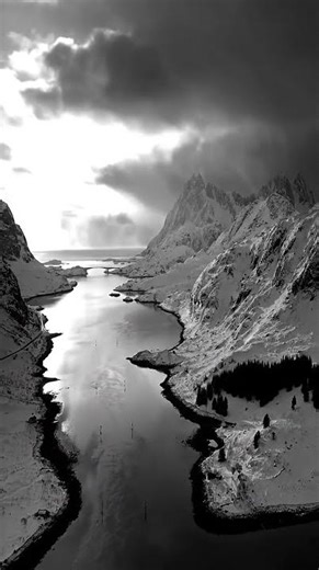 Stunning Contrast! Remote Lofoten Village Nestled Below Snow-Capped Mountains in Arctic Norway