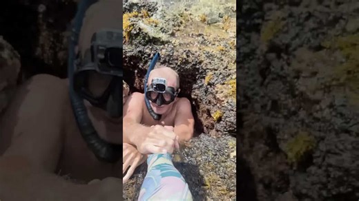 Diver attempts to swim through tiny hole