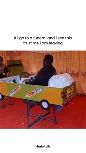 VIRAL VIDEOS on Instagram: "This video showcases a 30-second clip of a unique funeral procession where the deceased is displayed in a specialized, car-shaped casket that rotates automatically, captioned "If i go to a funeral and i see this trust me i am leaving" to highlight the shock and dark humor of the scene. The casket is painted to look like a taxi, complete with a license plate and steering wheel, spinning on a mechanical stand as onlookers observe the unconventional memorial. It generate