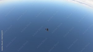 Skydiving. Freefly jump. Three skydivers are falling in the sky.