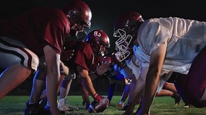 American Football Championship Start Teams Ready. Professional Players, Aggressive Face-off, Start Pushing, Tackling. Competition Full of Brutal Energy, Skill. Cinematic Slow Motion. Dramatic Sport