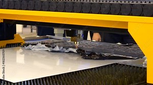Fiber laser machines for metal cutting close-up. A laser beam cuts the sheet metal in the manufacture. Industrial technologies, production processes