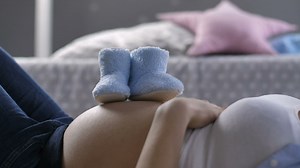 Woman laying down with baby shoes - Free Stock Video
