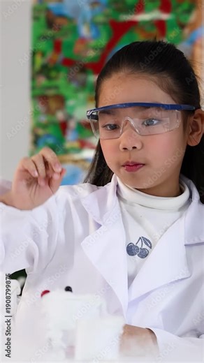 Asian Girl in Lab Coat Raising Hand During Science Experiment