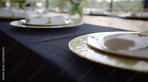 luxury tableware are standing on a decorated table for wedding dinner in a restaurant, close-up view