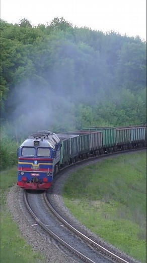 Blue diesel locomotive, black smoke and whistling turbine