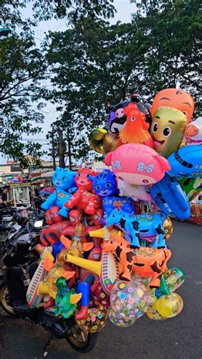 There are various colorful Hello Kitty cat balloons