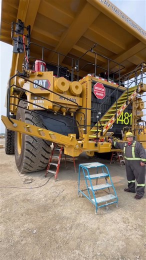 Demonstration of a ground access ladderstairs on als new Cat 793 haul truck—While conventional grab irons and steps do serve their purpose, removing potential for a slip #construction #dozer #buildozer #Caterpillar #crawlerdozer #engineering | Gael Crawford