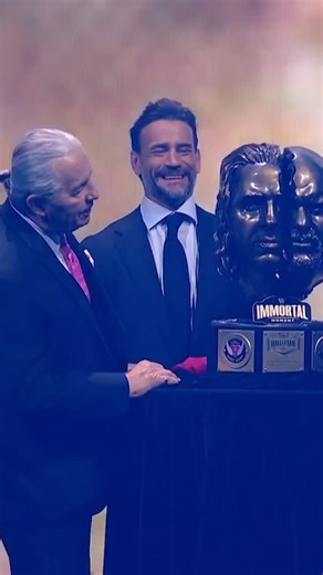 WWE on Instagram: "@cmpunk welcomes out @brethitmanhart and @steveaustinbsr to receive the first-ever “WWE Immortal Moment” for their epic encounter at WrestleMania 13. 👏 #WWEHOF"