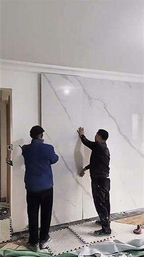 installing large ceramic tiles and striped board panels on building walls for room decoration #short