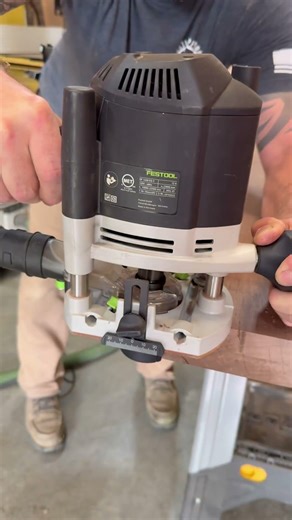 Festool OF 1400 EQ-F laying down a clean bevel on this solid black walnut console table.