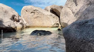 A video showing slow-motion water movement between rock formations, filmed in smooth camera motion. Perfect for topics related to nature, relaxation, and adventure. Location: Corsica