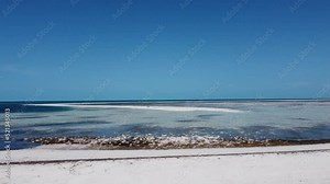 HD of the flight off the white sandy island beach towards sandbar