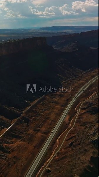 Splendid relief in the Utah National Park. Amazing scenery of rocks and valleys lit by sun from aerial perspective. Vertical video